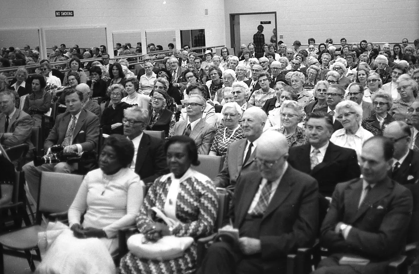 A packed hall at an early assembly of the movement, in a black and white photograph