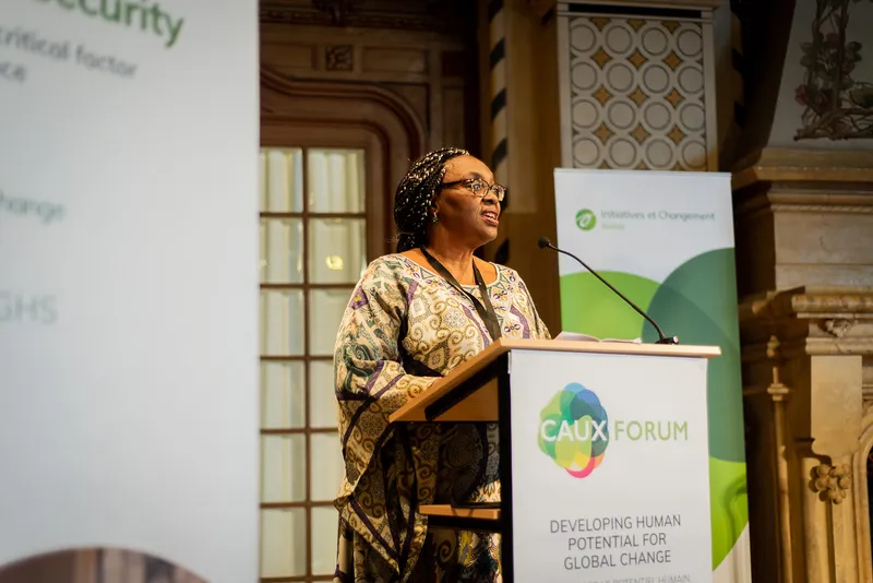 A speaker at a lectern during a session at the Caux Forum